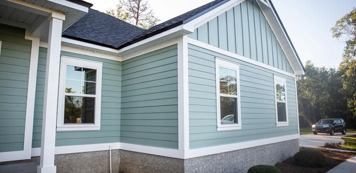 a house with a painted roof, painted exterior walls, and glass windows